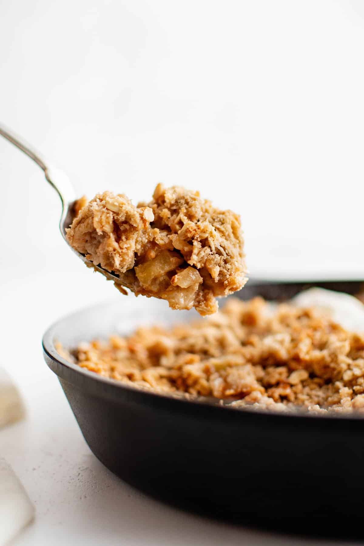 caramel apple crisp on a serving spoon