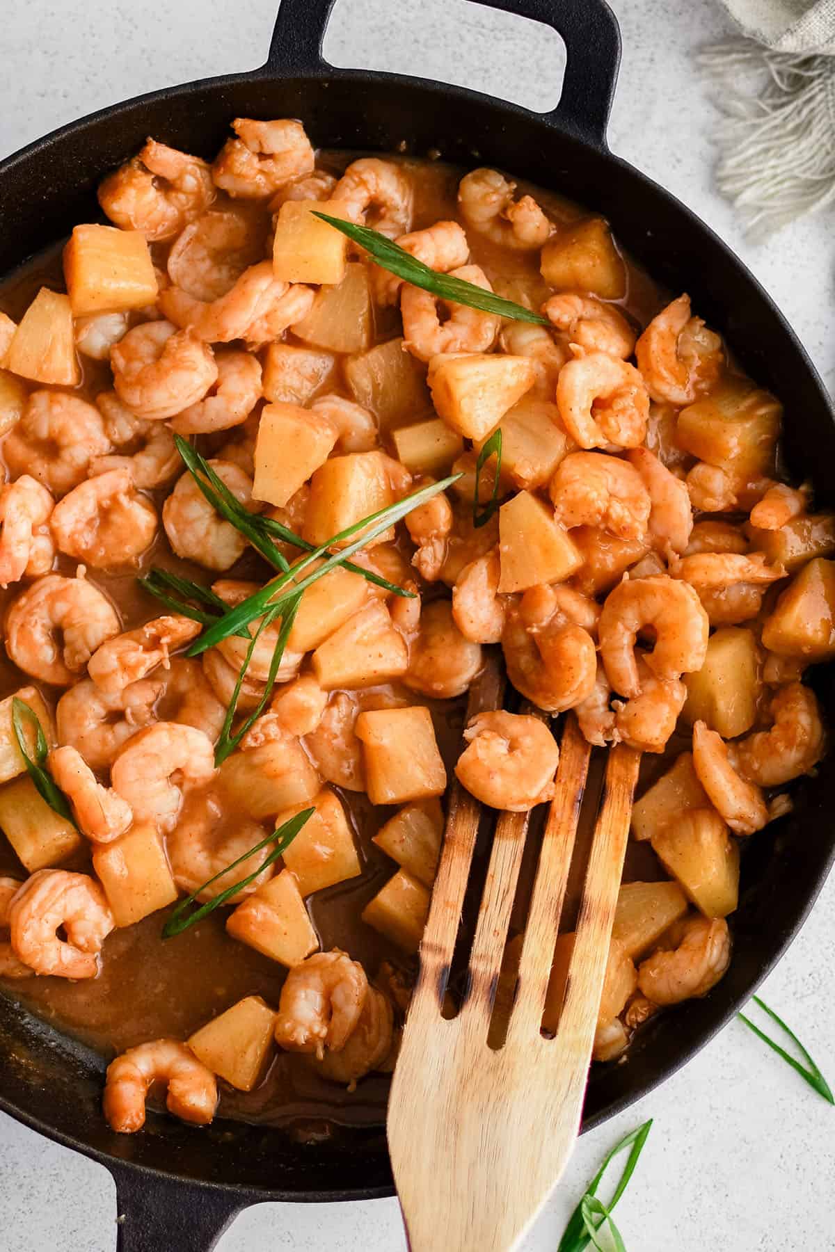 sweet chili shrimp in a skillet with sliced green onions