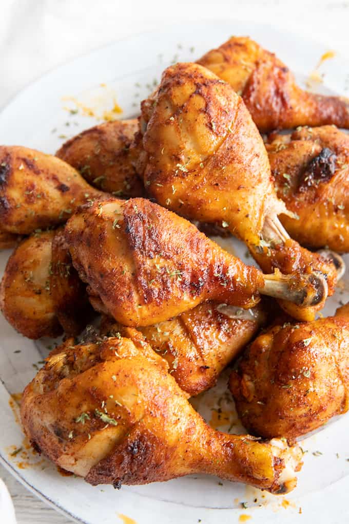marinated baked chicken drumsticks arranged on a plate