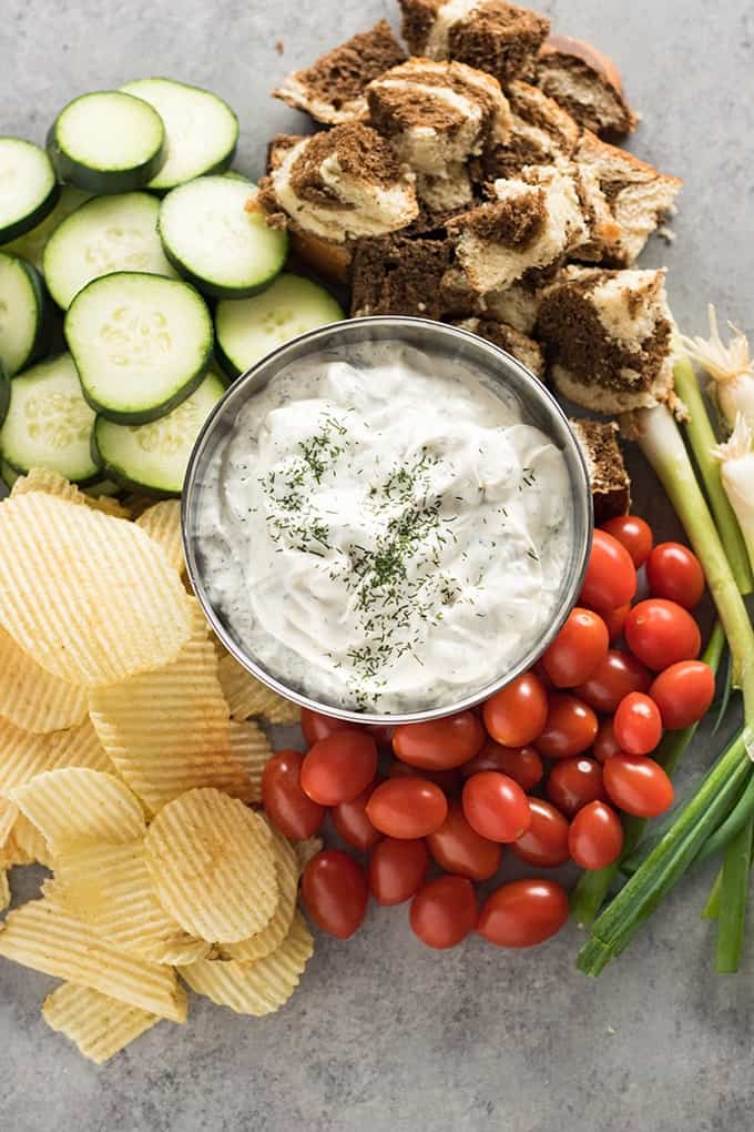 dill dip with vegetables chips and bread