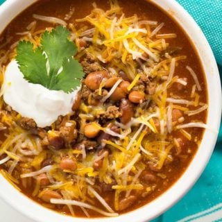 The best instant pot chili with beef and beans topped with cheese