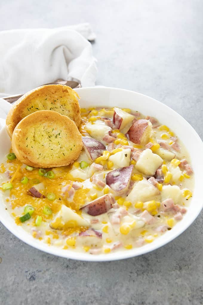 corn chowder with potatoes and ham in a bowl