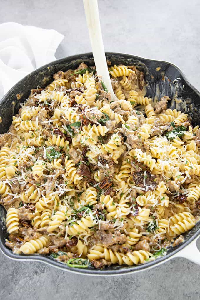 rotini in a skillet with spoon