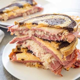 stacked reuben sandwich on a plate