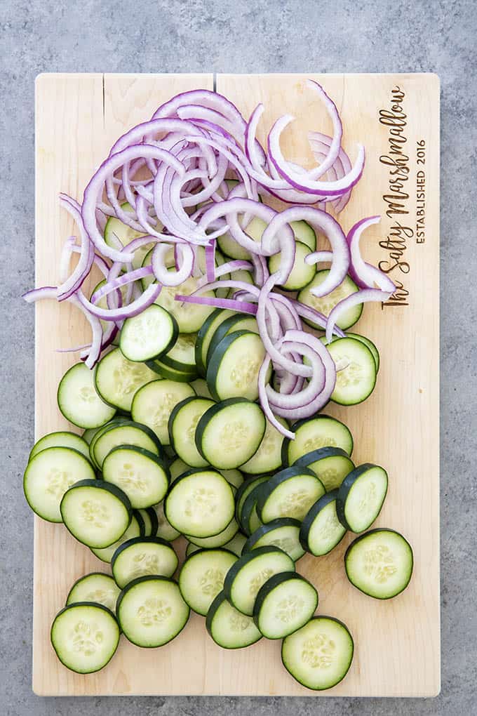 cucumber and onion for cucumber salad on cutting board
