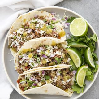 three beef machaca tacos on a plate