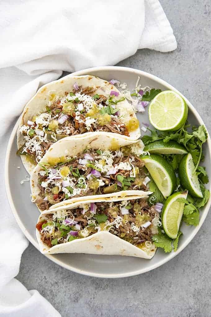 three beef machaca tacos on a plate