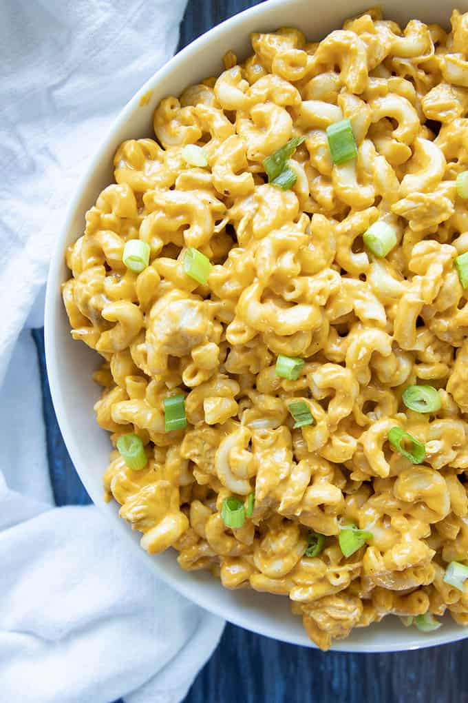 close up photo of buffalo chicken mac and cheese in a white bowl