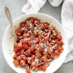 tomato salad with dressing and cheese in bowl