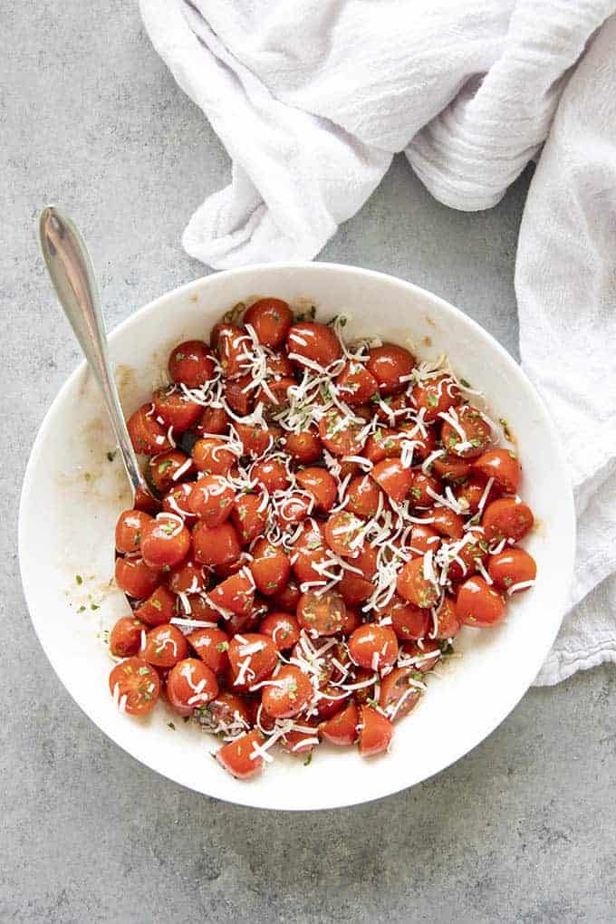 tomato salad with dressing and cheese in bowl