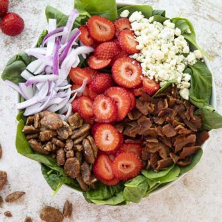 spinach salad with strawberries in a large bowl