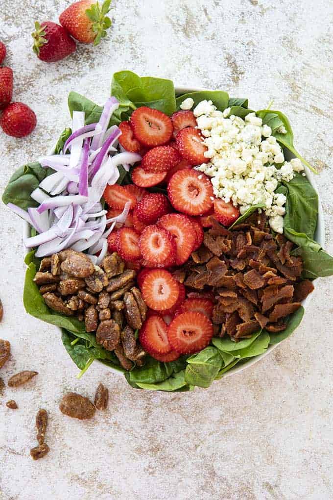 spinach salad with strawberries in a large bowl