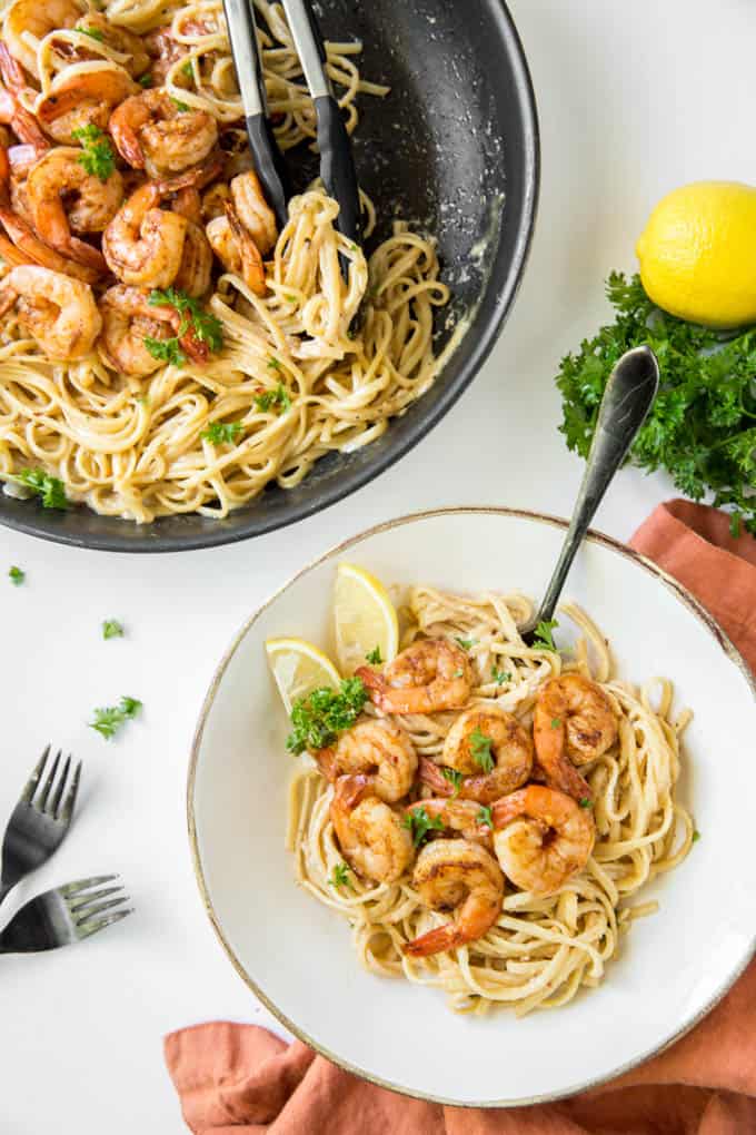 A large bowl of cajun shrimp pasta with a fork.