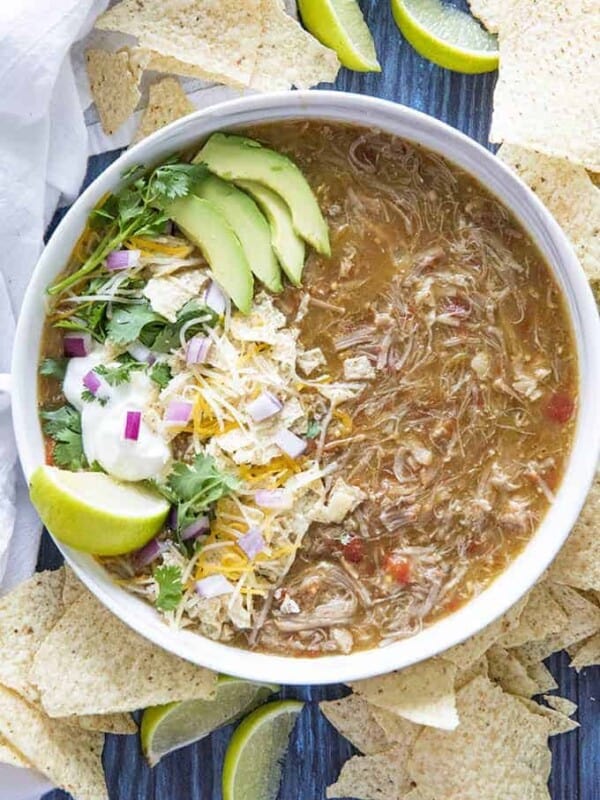 chili verde made in instant pot in a large bowl with toppings