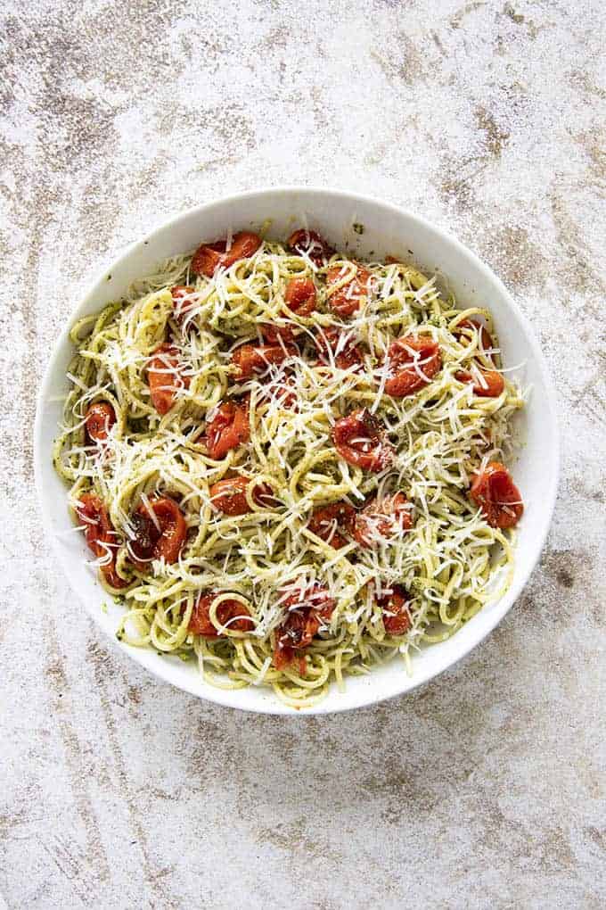 pasta in a bowl with pesto and roasted tomatoes