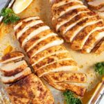 Oven baked chicken breast on a sheet pan.