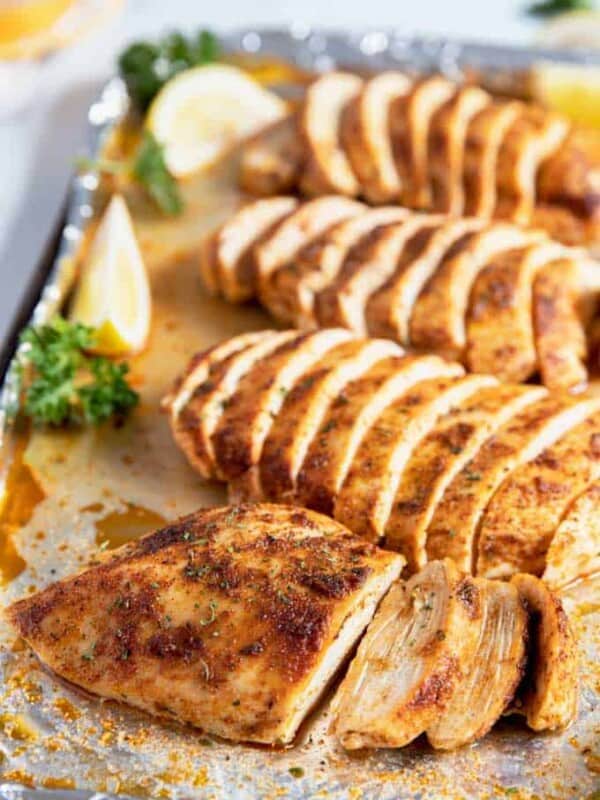 Baked Chicken Breast sliced on a baking sheet.