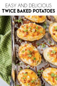 twice baked potatoes on a pan with diced bacon and chives.
