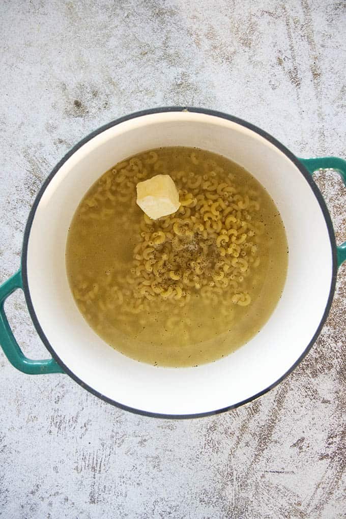 macaroni with water and butter in pot