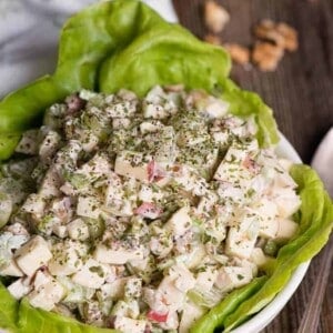 bowl of waldorf salad on lettuce in bowl