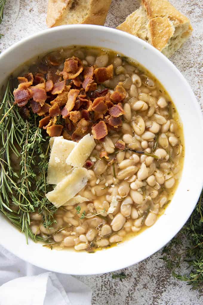 photo of white bean soup topped with bacon