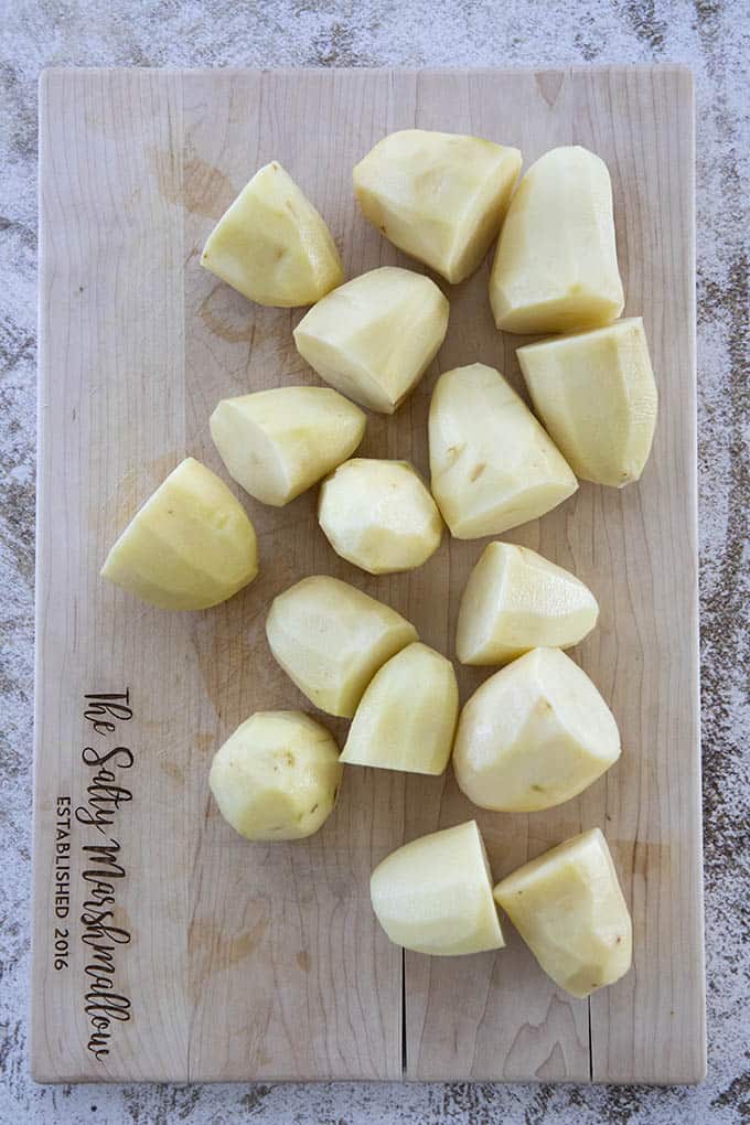 cutting board with potatoes
