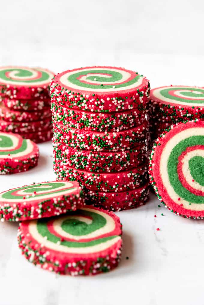 An image of red, white, and green pinwheel cookies stacked in a tower.