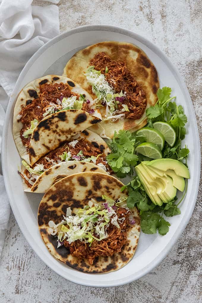 chicken tinga in taco shells on a platter