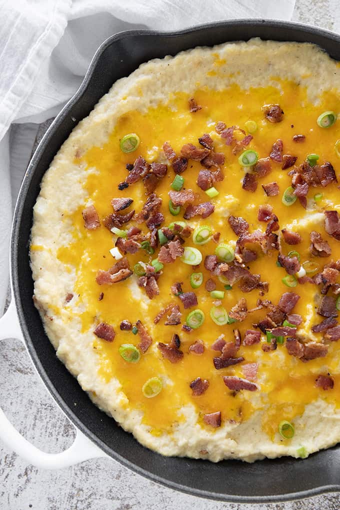 cauliflower casserole topped with bacon cheese and green onion