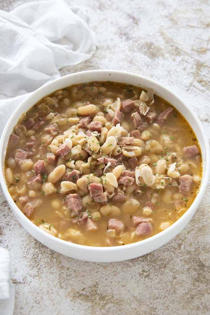 ham and bean soup in a white bowl