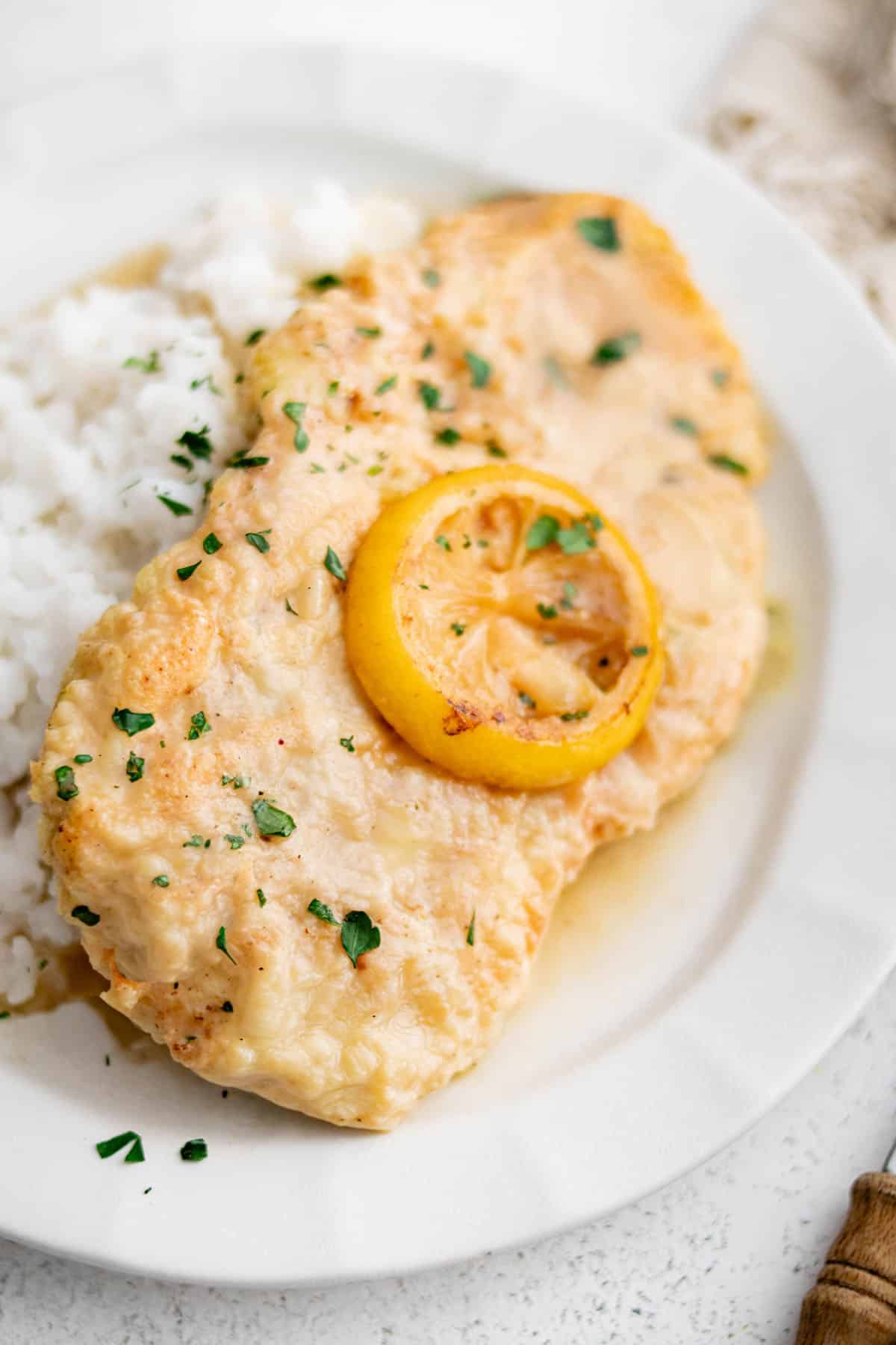 chicken francese garnished with a lemon slice on a plate