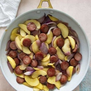 kielbasa apples and onions in a skillet