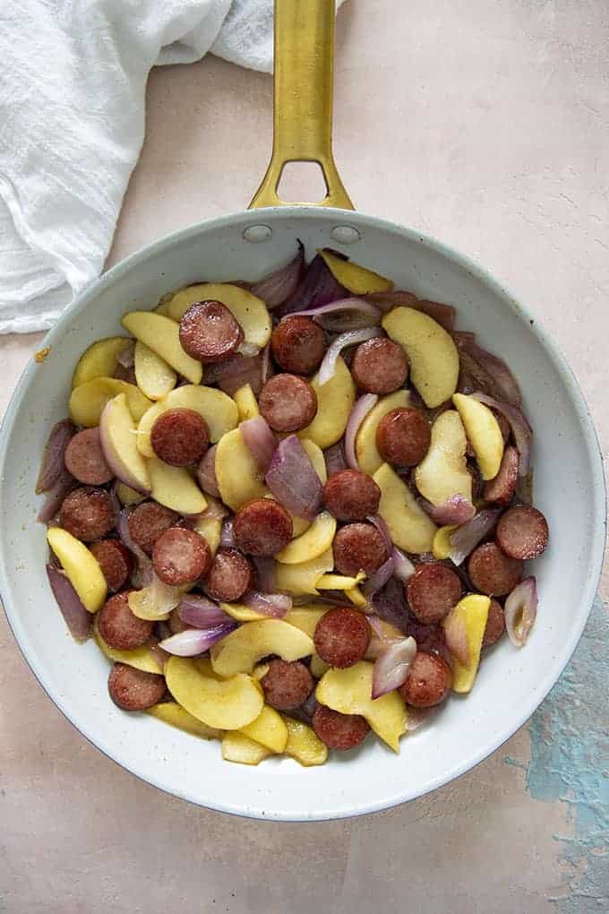 kielbasa apples and onions in a skillet