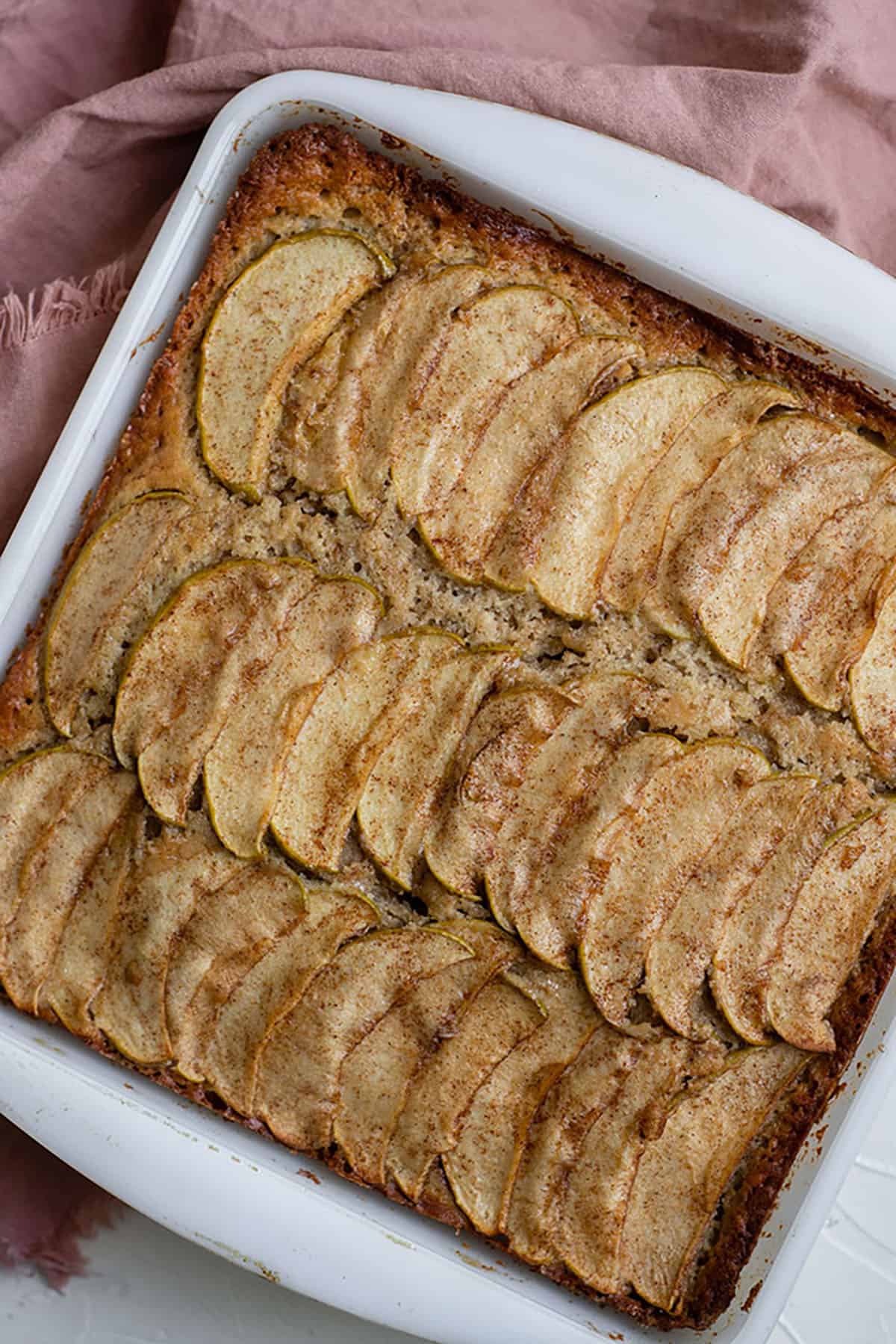 cake with sliced apples in a pan
