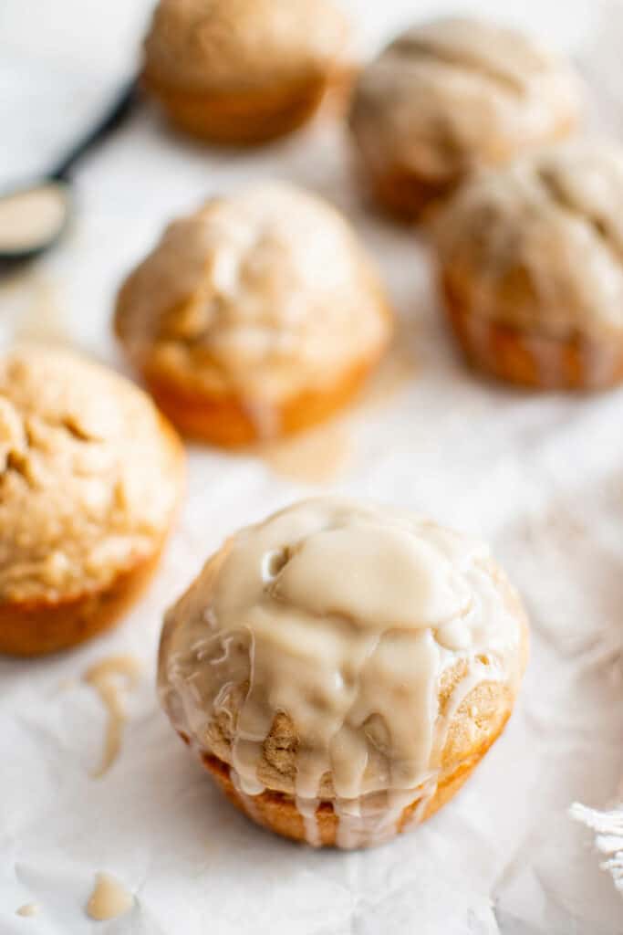 banana brown sugar maple muffins on a plate with glaze
