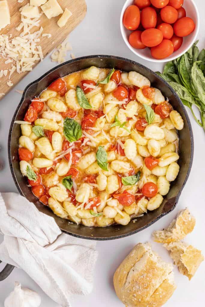 pan of brown butter gnocchi with tomatoes and basil