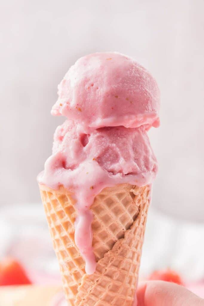 scoops of strawberry ice cream in a cone
