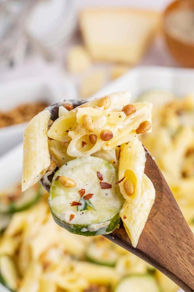 wooden spoon with a scoop of pasta with zucchini