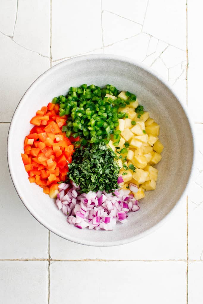 ingredients for pineapple salsa in a bowl