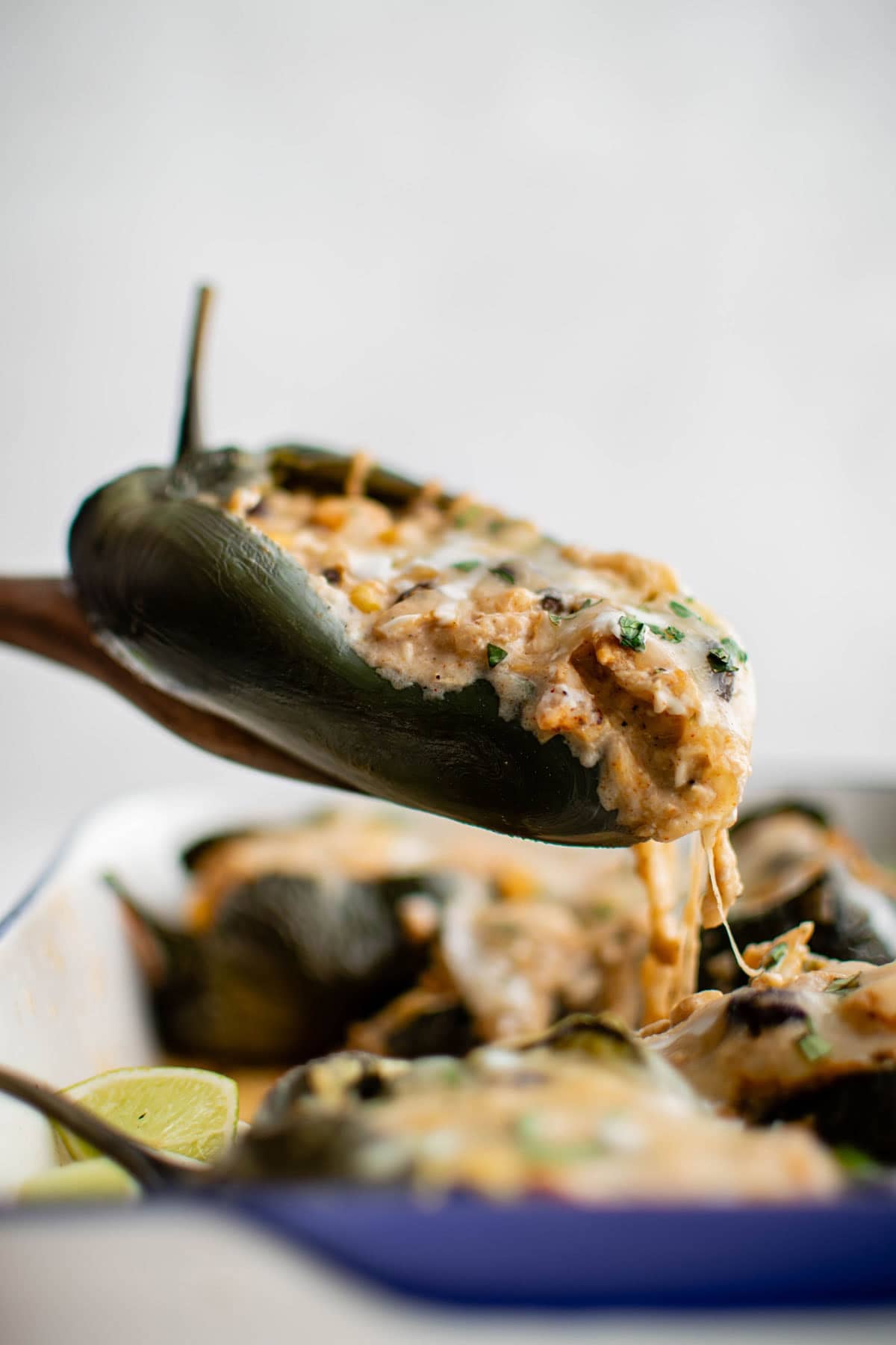 a stuffed poblano pepper on a serving spoon