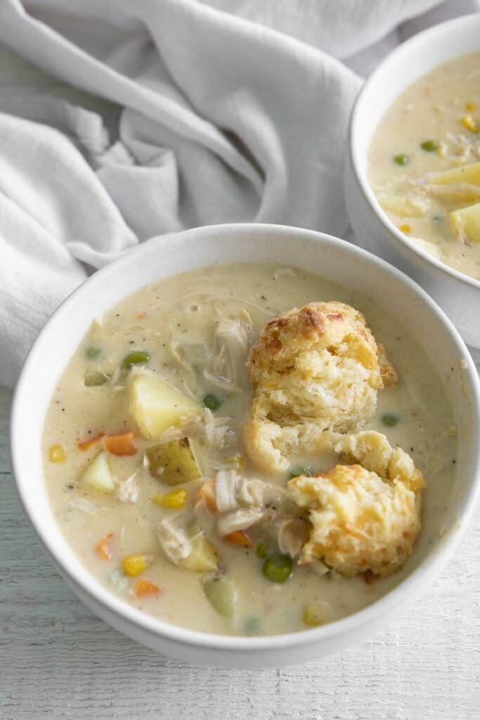 bowl of chicken pot pie soup with biscuits