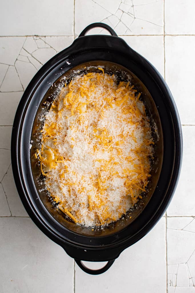 sliced potatoes, cream and cheese in the crockpot