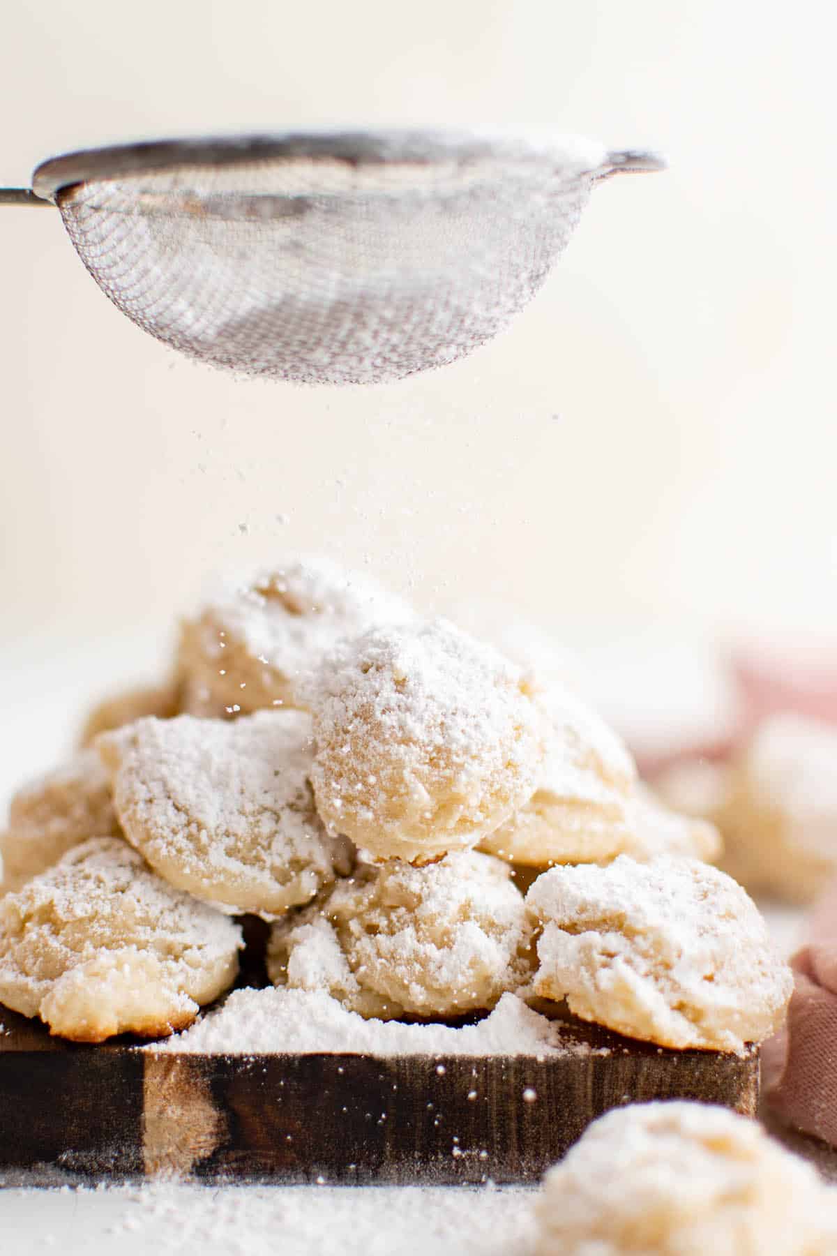 photo of cookies made with cream cheese dusted with powdered sugar