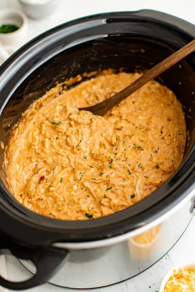 cooked shredded queso chicken in the crockpot