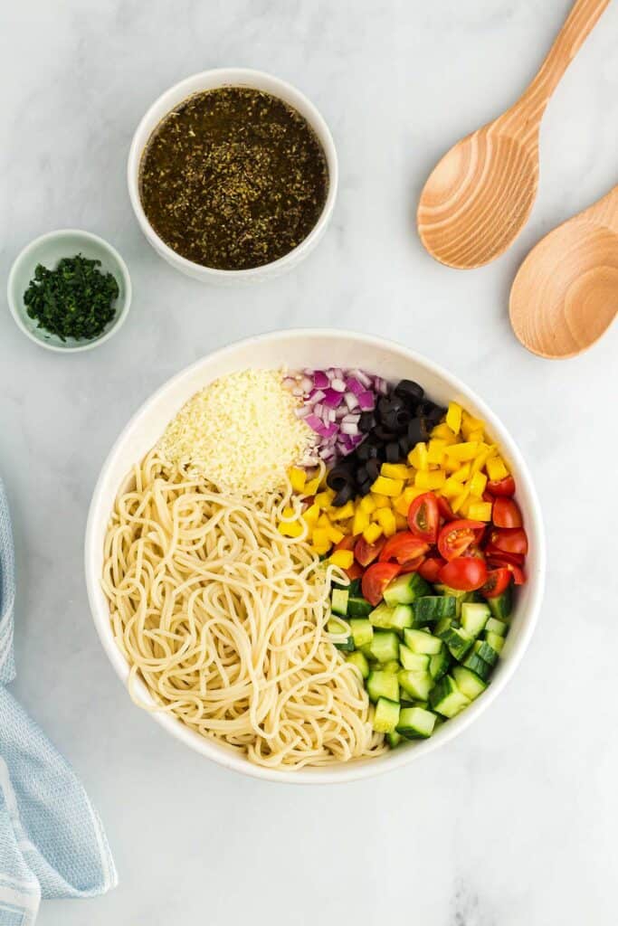 ingredients to make spaghetti salad in a bowl