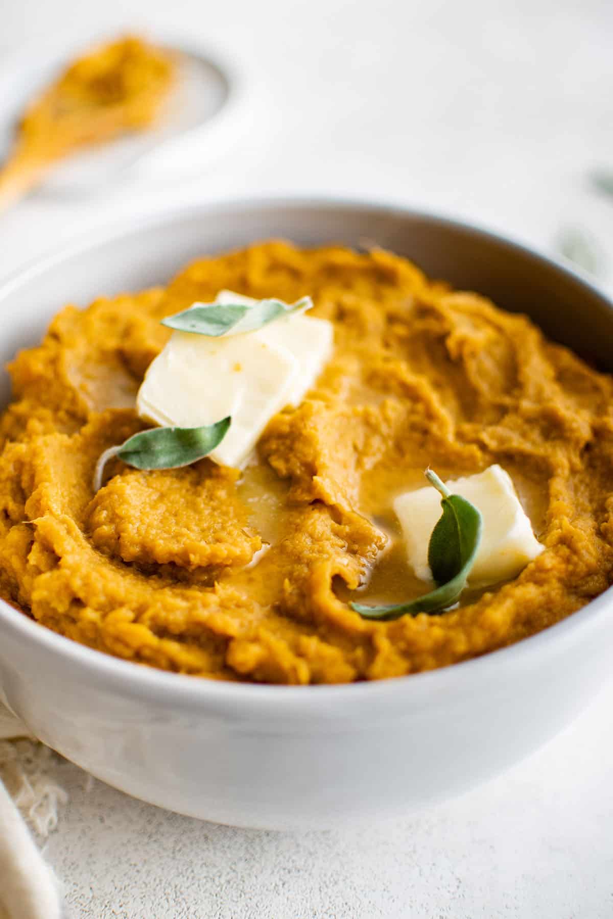 mashed sweet potatoes in a bowl with butter