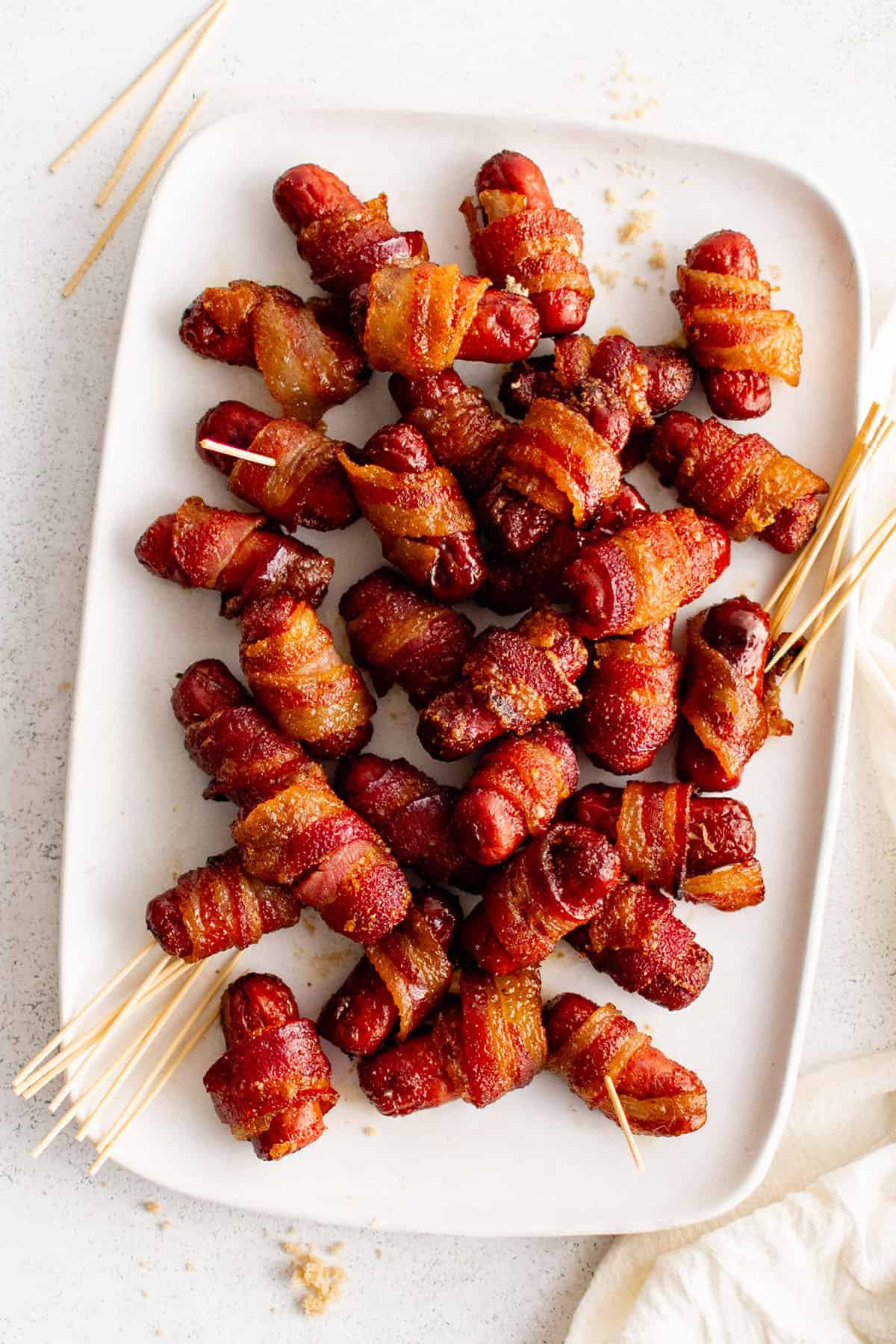 lil smokies wrapped in bacon on a plate