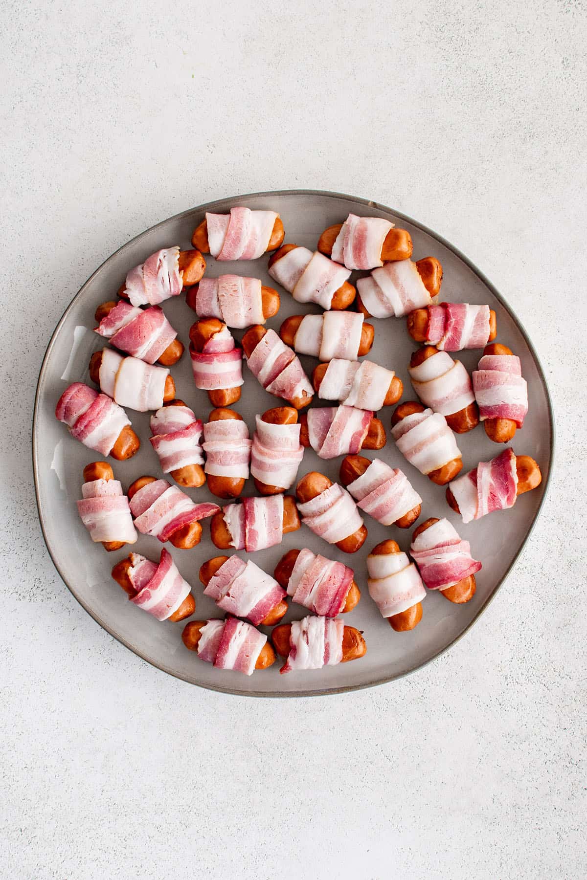 lil smokies with bacon wrapping on a platter