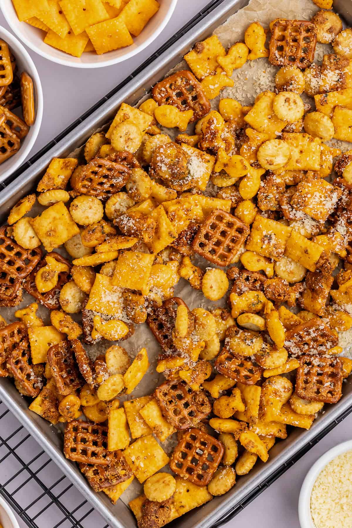ranch and parmesan snack mix on a baking sheet