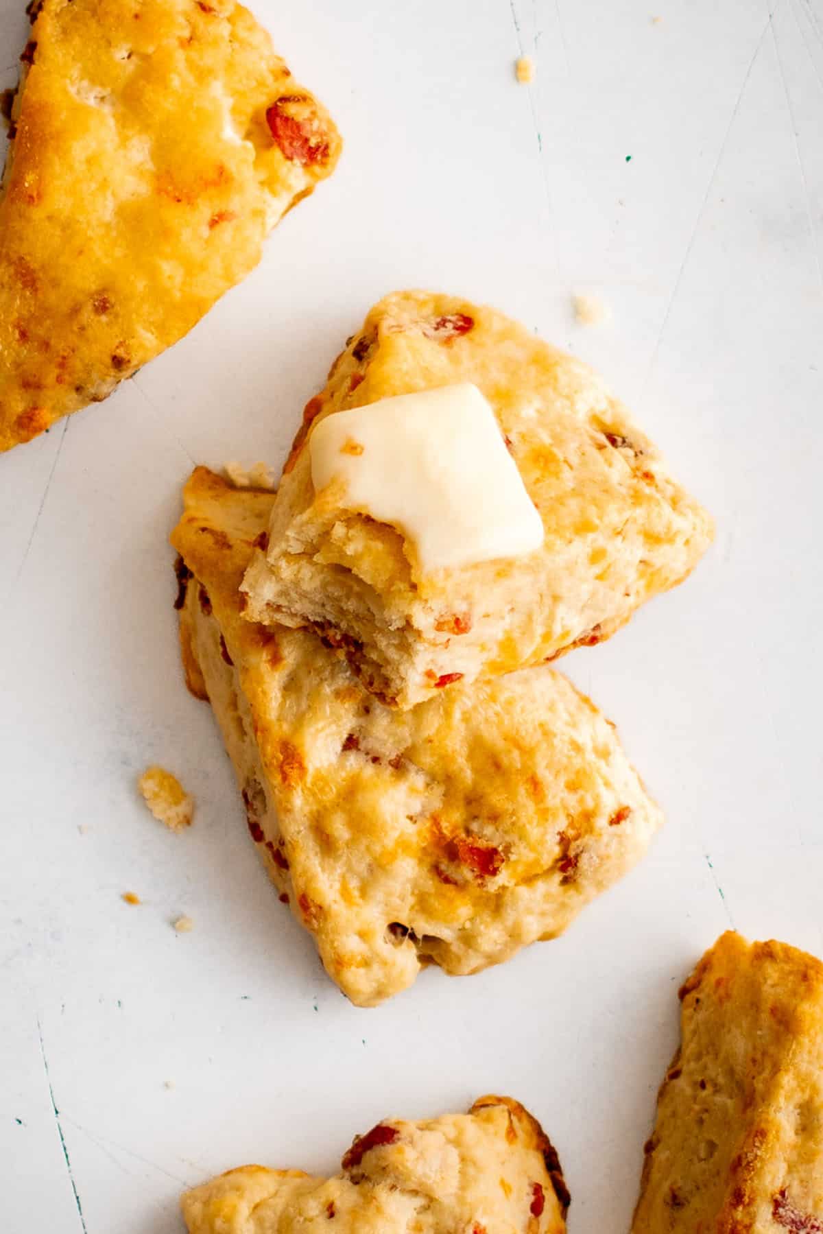 bacon cheese scones on a plate with butter